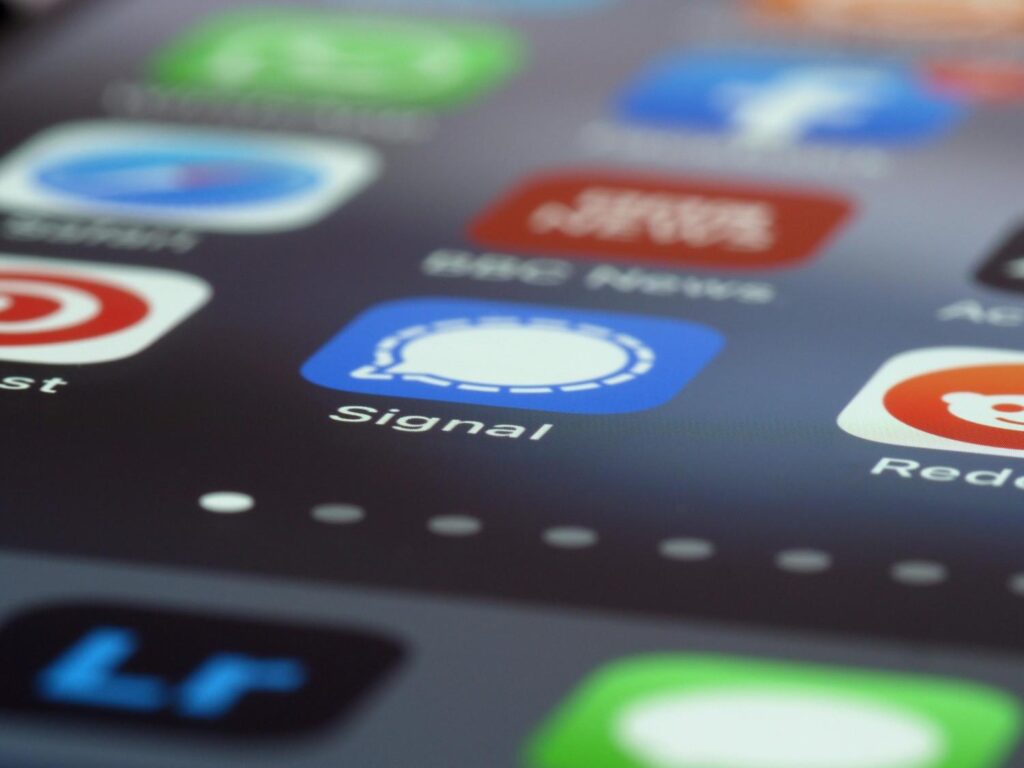  "Individual surrounded by smartphones, fitness trackers, and wellness supplements, representing over-optimization"