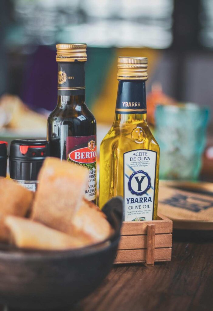 "Olive oil being used in salad dressing, sautéing vegetables, and as bread dip in traditional Mediterranean meal preparation" olive oil zaitoon oil uses quality guide
 
