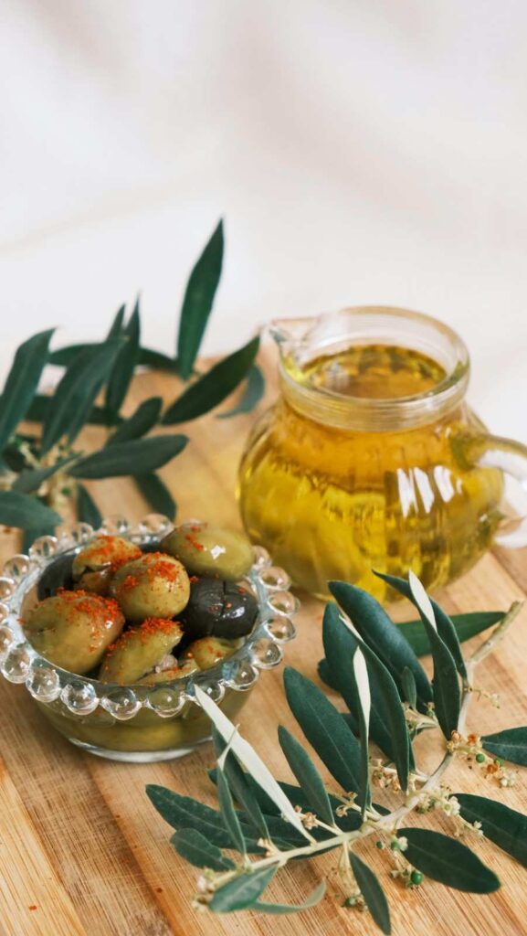 "Different types of olive oil including extra virgin, virgin, and refined varieties, are shown with fresh olives."