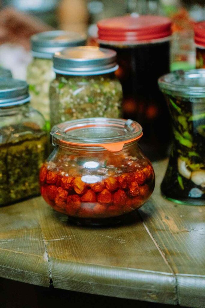 Assorted fermented foods including yogurt, kimchi, sauerkraut, and kombucha arranged on a table