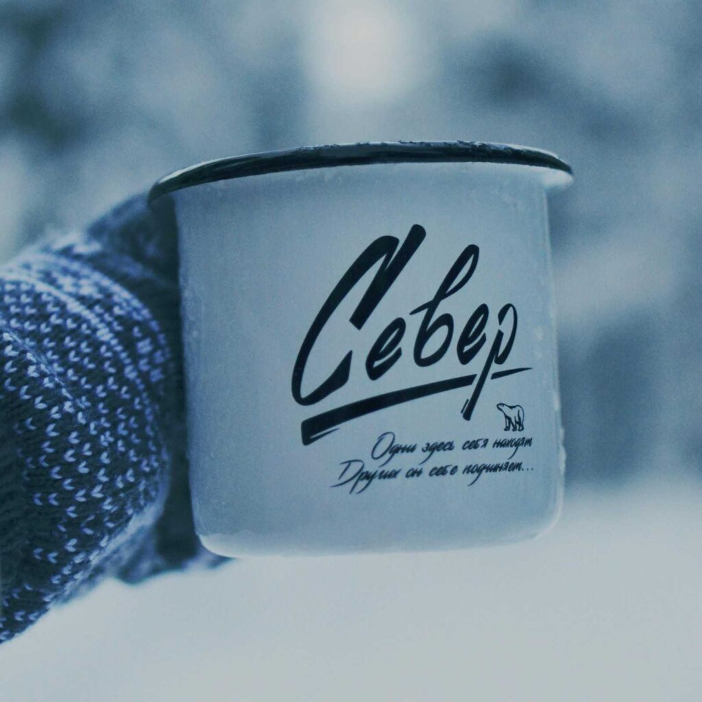 A person in cozy clothing wearing wool gloves and holding a steaming mug, representing practical comfort measures for cold hands. Cold hands and feet causes
