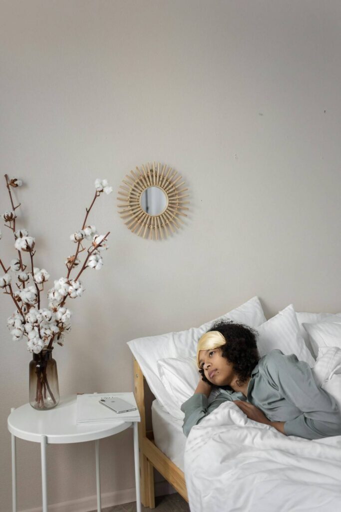 A person reading a book before sleep with warm lighting, representing healthy sleep routine and regularity
