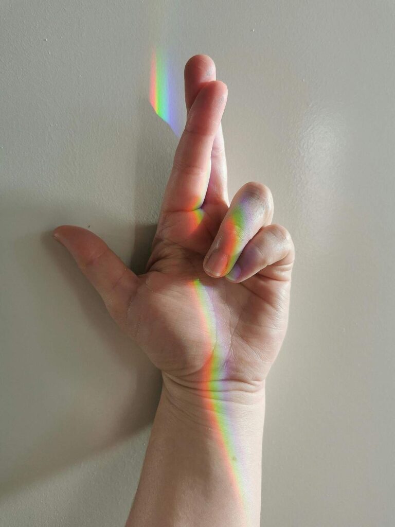Person's hands showing fingers turning white and blue from vasospasm, representing Raynaud's phenomenon