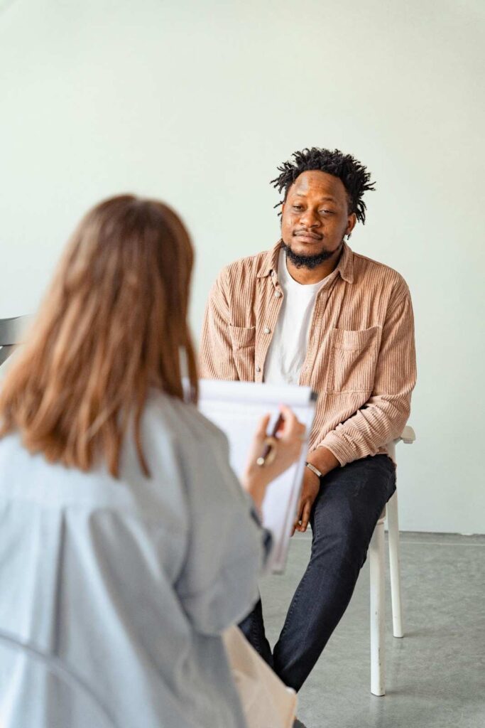 A patient speaking with a doctor in a medical office, representing the importance of professional guidance before starting any weight loss program or natural weight loss tips
